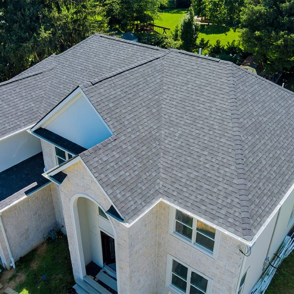 Aerial view of asphalt shingles roofing construction, the house with new window