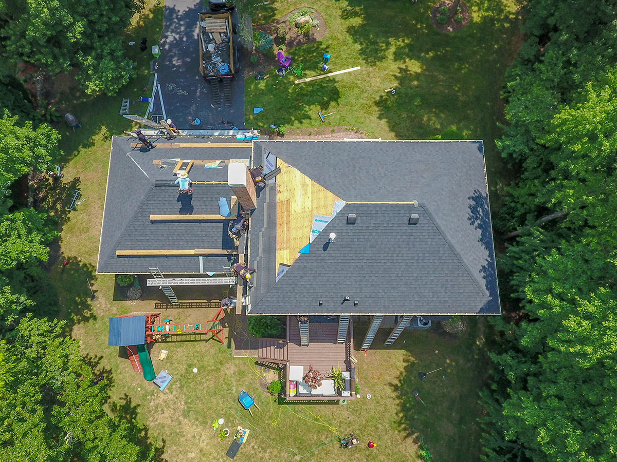 Aerial view of roofers replacing shingles